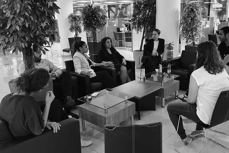 Mentoring session with a junior designer, in black and white.